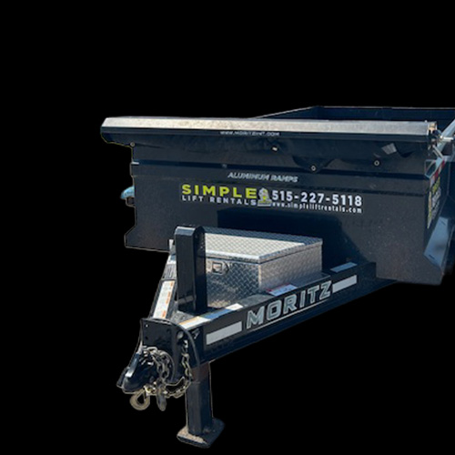 A black Moritz utility trailer with a metal toolbox and hitch, displaying "Simple Lift Rentals" and a phone number on the side, is situated outside Carlisle Hardware in Carlisle, Iowa, against a solid black background.
