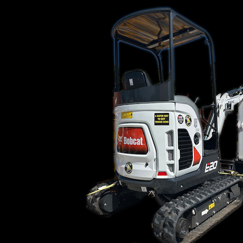 A white Bobcat E20 compact excavator with an open cab and visible tracks, displayed against a solid black background. The vehicle features brand logos and various decals on its rear side, and is available for rent at Carlisle Hardware in Carlisle, Iowa.